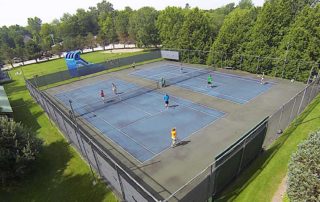 Couples playing tennis on the inn courts